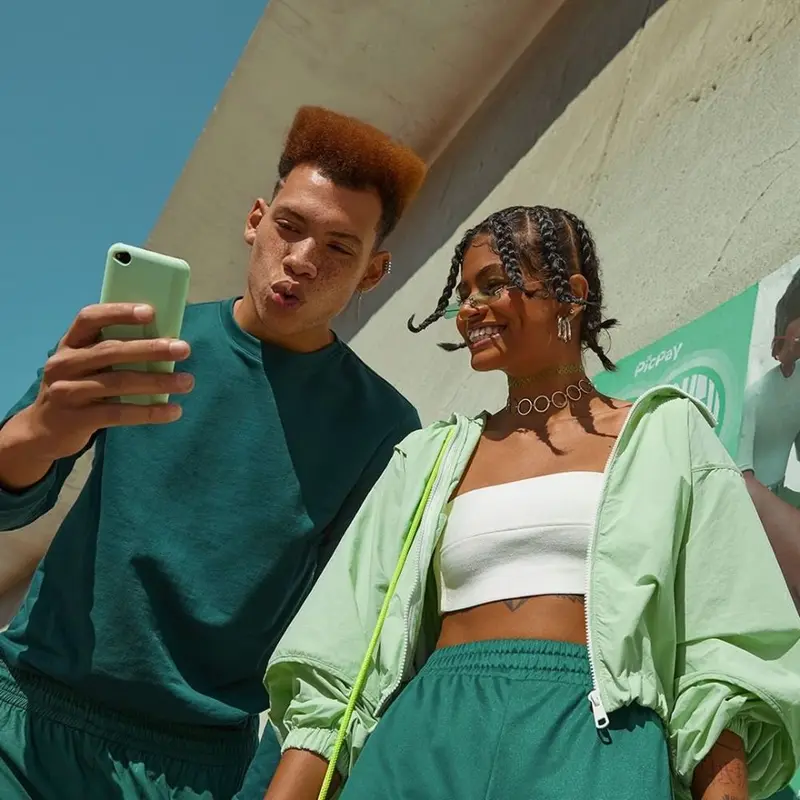 Colleagues reviewing a payment together on a phone